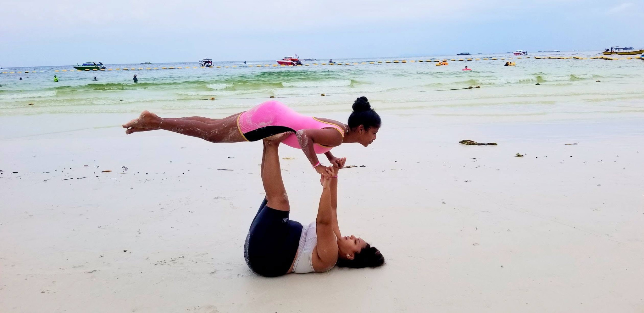 Partner yoga on the beach